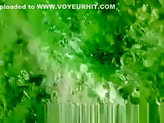 Woman sunbathing topless in grass