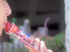 Teen girl sucks on an ice cone