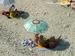 Two nudist couples spied in the beach