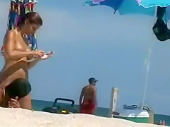 Woman removes her bikini on a beach