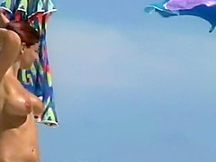 Woman removes her bikini on a beach