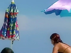 Woman removes her bikini on a beach