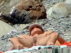 Skinny nudist woman sunbathing