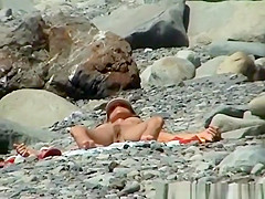Skinny nudist woman sunbathing