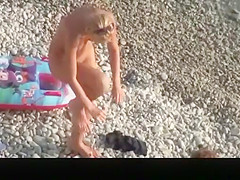 Hot blonde nudist woman swimming