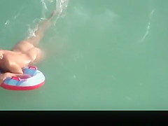 Hot blonde nudist woman swimming
