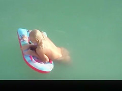 Hot blonde nudist woman swimming