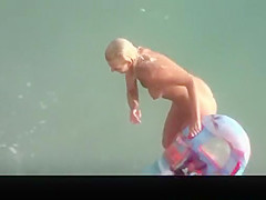 Hot blonde nudist woman swimming