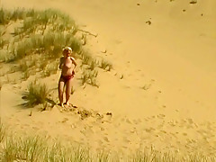 Busty babe Nadine at the beach