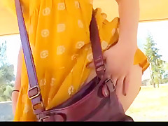 Beauty brunette flashing her body in the park