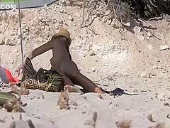 Seductive naked babe spied on a beach