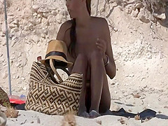 Seductive naked babe spied on a beach