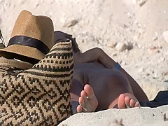 Seductive naked babe spied on a beach