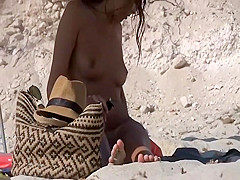 Seductive naked babe spied on a beach
