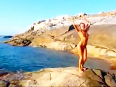 Nude beach hot blond posing on the rocks