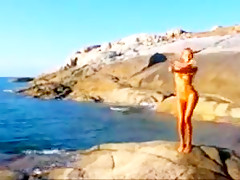 Nude beach hot blond posing on the rocks