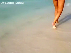 Woman in white bikini thong walking