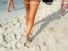 Woman in white bikini thong walking