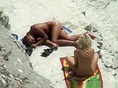 Nude couple secretly filmed in the rocky beach