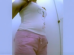 Chubby woman changing bikini for clothes
