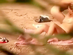 Love making spied on a sandy beach