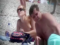 Topless blonde woman at beach