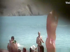 Topless blonde woman at beach