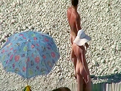 Nudist couple goes take a swim