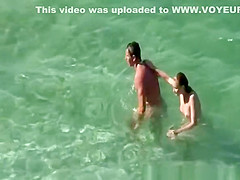 Nudist couple goes take a swim