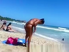 Busty woman sunbathing in bikini