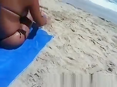Busty woman sunbathing in bikini
