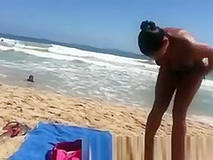 Busty woman sunbathing in bikini