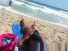 Busty woman sunbathing in bikini