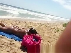 Busty woman sunbathing in bikini