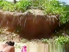 Busty woman sunbathing in bikini