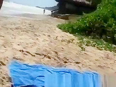 Busty woman sunbathing in bikini