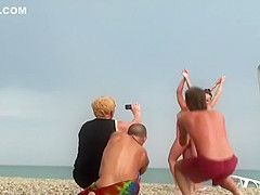 Nude girls pose for a photo and a voyeur