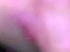 Nudist woman laid down on her belly sunbathing