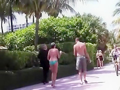 Voyeur follows milfs to the beach