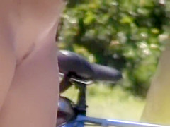 Zooming on a nudist girl's shaved pussy