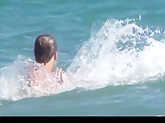 Big boobs woman playing with cock on nude beach