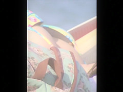 Sexy brunette sunbathes her body on the beach