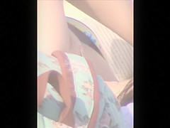 Sexy brunette sunbathes her body on the beach