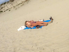 Adorable topless girl with big boobs enjoys the sun
