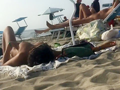 Adorable topless girl with big boobs enjoys the sun