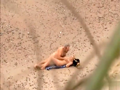 Old daddy tempts the young blonde on a beach