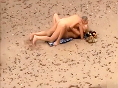 Old daddy tempts the young blonde on a beach