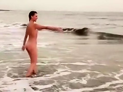 Beautiful naked brunettes splash around in the ocean