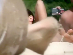 Sexy brunette lies naked in the sand