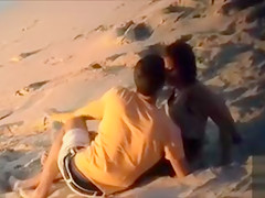 Attractive doll enjoys a man's cock in the sand